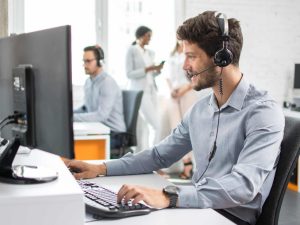 Smiling handsome customer support operator agent with hands-free